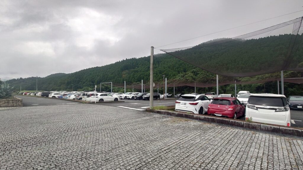 青島ゴルフ倶楽部の広い駐車場と打球よけネット